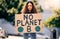 Woman, poster and portrait in street for planet, climate change and sustainable future in city. Girl, cardboard sign and