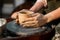 Woman Potter Hands Shaped Mug From Clay. The Process of Creating Pottery On a Potter`s Wheel. Working in Ceramics Studio