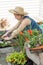 Woman potting plants on a hot spring day