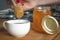 Woman pour honey into a cup of coffee as sweetener