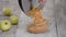 Woman pouring apple filling into glass bowl.