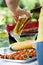 Woman pouring beer on barbecue