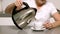 Woman pouring boiling water from kettle into cup