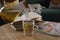 Woman pouring brewed tea into cup at table in living room, closeup. Cozy home atmosphere