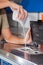 Woman Pouring Detergent Powder In Washing Machine