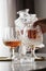 Woman pouring and drinking brandy of lead crystal bottle in cognac snifter glasses