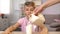 Woman pouring fresh milk in glass for sons healthy breakfast, calcium nutrition