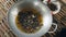  Woman pouring fried oil into a wok with deep-frying tarantulas