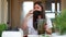 Woman pouring green smoothie into glass