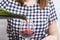 Woman pouring herself a glass of red wine. Woman drinking alcoholic beverages alone. Female alcoholism