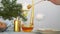 WOman pouring honey in glass bowl. Raw healthy food