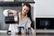 Woman pouring hot water into teapot