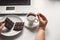 Woman pouring huge amount of sugar into coffee cup