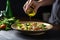 woman pouring olive oil over chickpea salad