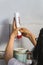 woman pouring shampoo in a glass blender