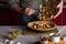 Woman pouring spiced apples stuffing for the apple pie in the bakery dish with dough