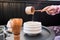 Woman pouring water at the bowl while preparing matcha tea