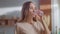 Woman pouring water into glass from jug. Lady drinking water at home