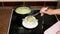 Woman pours cheese soup in bowl