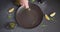 Woman pours cooking olive oil onto black ceramic plate cooking tuna carpaccio