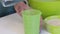 A woman pours a glass of decanter water. Near the container with flour. Close-up shot