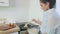 Woman pours the pancake batter into a hot pan with a large spoon