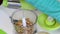 A woman pours peeled almonds into the bowl of a blender for grinding. Cooking filling in glazed sweets.