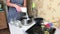 A woman pours sugar into a container with blueberries. Making blueberry jam at home. Preservation and preparation of blueberries