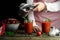 A woman pours tomato juice from the juicer