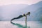 woman practice yoga on the pool above the Mountain peak