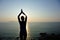 Woman practice yoga at sunrise seaside