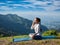 Woman practices pranayama in lotus pose outdoors