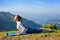 Woman practices yoga asana bhujangasana cobra pose