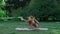 Woman practices yoga outdoors. Balance standing on hands. Female doing yoga