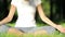 Woman practices yoga in the park