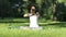 Woman practices yoga in the park