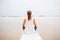 Woman practices yoga at the seashore on overcast day