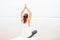 Woman practices yoga at the seashore on overcast day