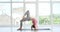 Woman practicing chakrasana at fitness studio