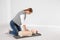 Woman practicing first aid on mannequin