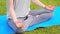 Woman practicing morning yoga meditation at the park, Cropped view