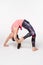 Woman practicing yoga Bridge pose on white