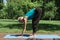 woman practicing yoga and doing Halfway Lift pose