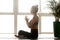 Woman practicing yoga, Easy Seat exercise, Sukhasana pose with n