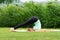 Woman practicing Yoga Halasana Plow pose