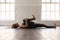 Woman practicing yoga, lying in Knees to Chest pose, Apanasana