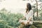 Woman practicing yoga in pose of lotus in forest.