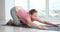 Woman practicing yoga pose variation at fitness studio