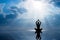 Woman practicing yoga, silhouette on the beach at sunset