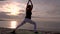 Woman practicing yoga on sunrise on the beach. Outdoors sports. Healthy living.